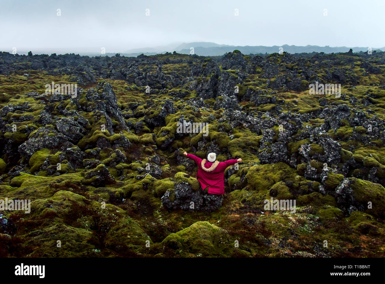 Woman enjoying lava field scenery in Iceland Stock Photo