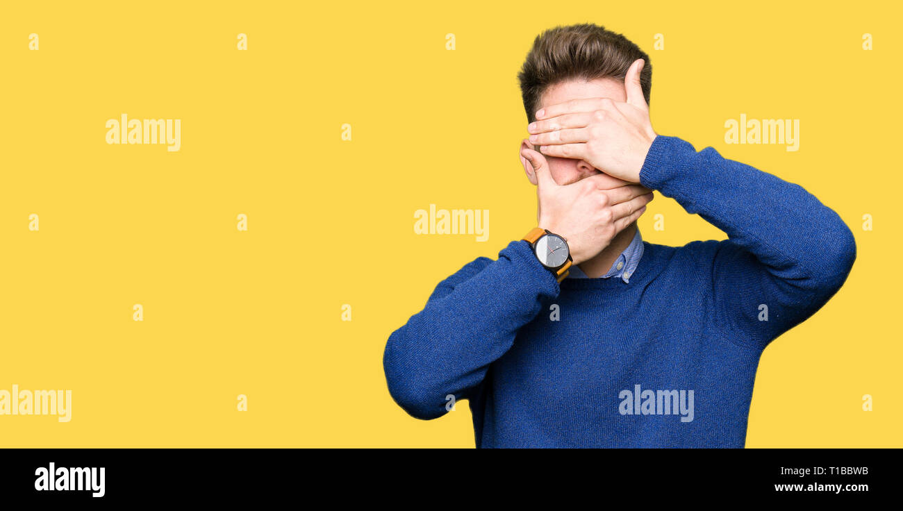 Young handsome bussines man Covering eyes and mouth with hands ...