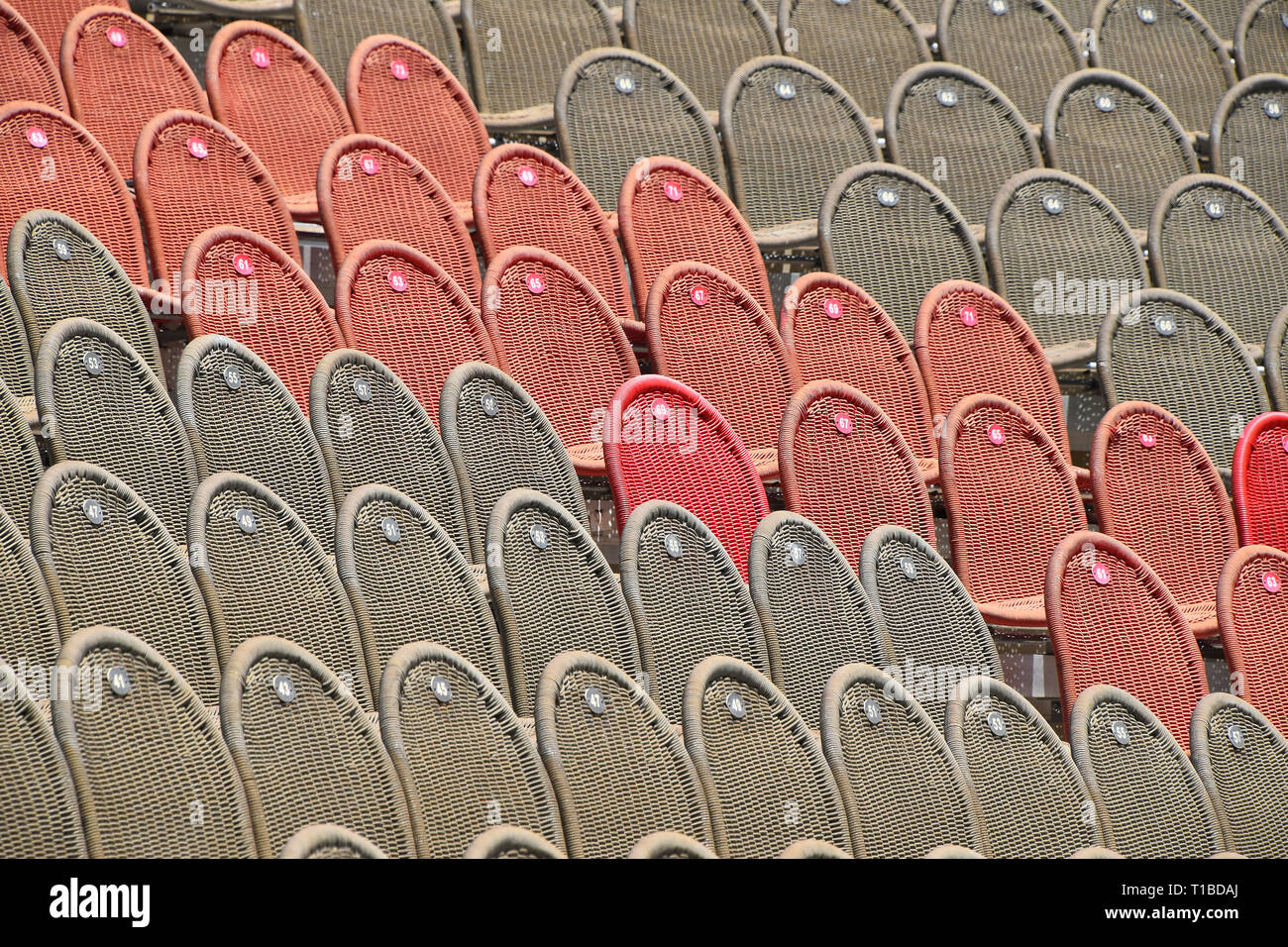 Rows of empty grey and red seats in open air concert hall auditorium ...