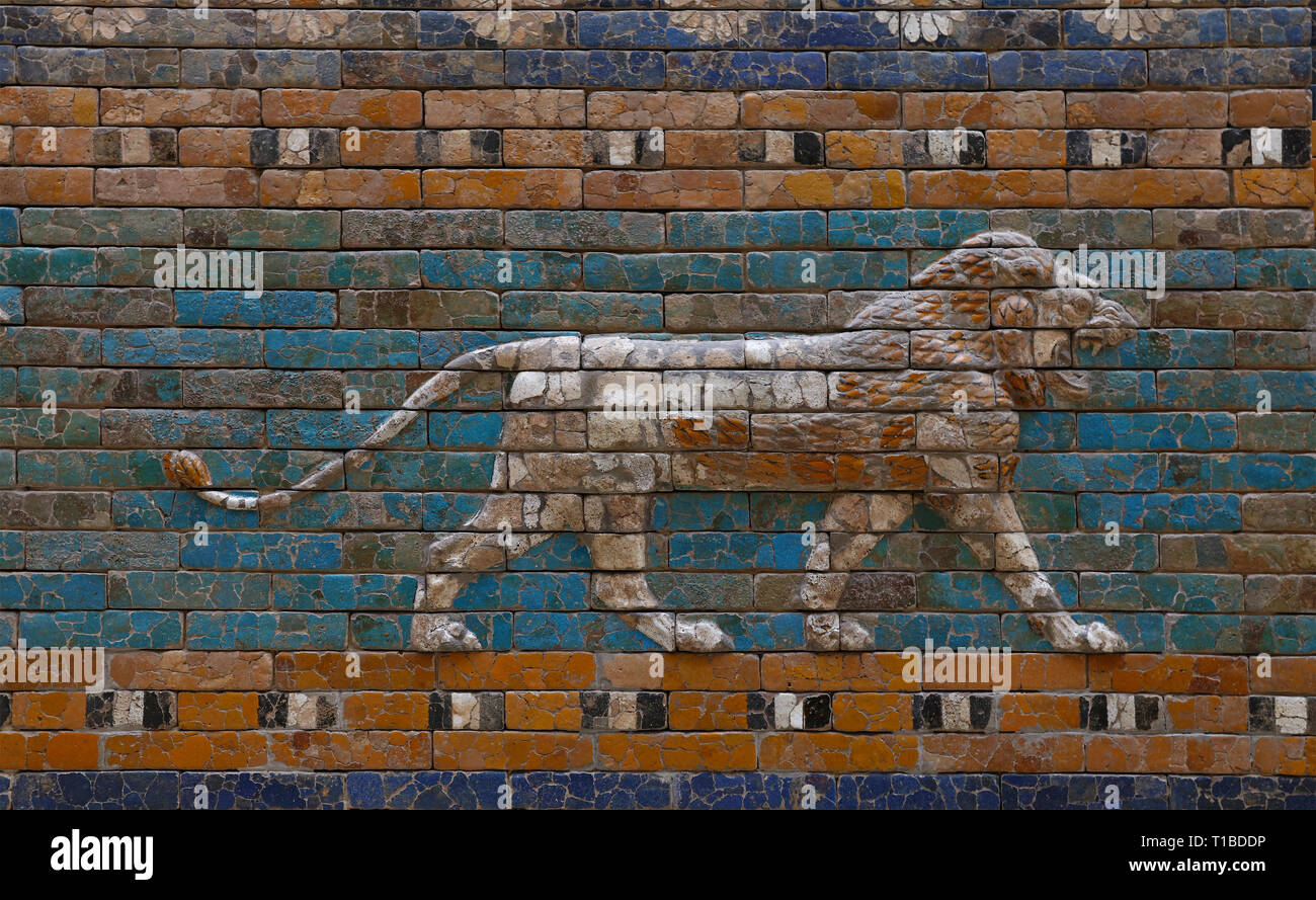 Close up beautiful glazed tiled bricks bas relief, decoration on ancient walls of Ishtar Gate of Babylon with images of Mesopotamian lions symbolizing Stock Photo