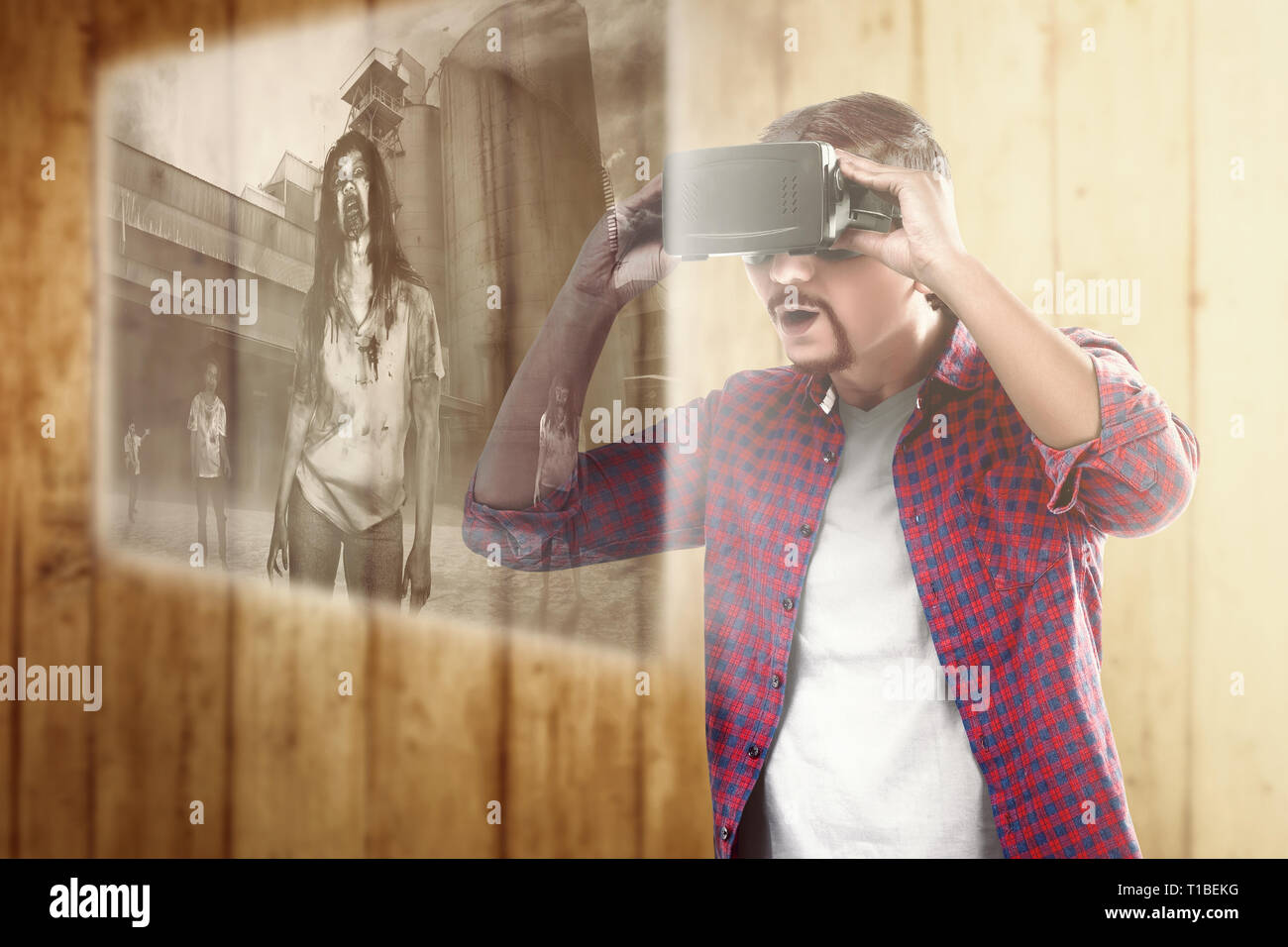 Asian man looking at digital interface with virtual reality device