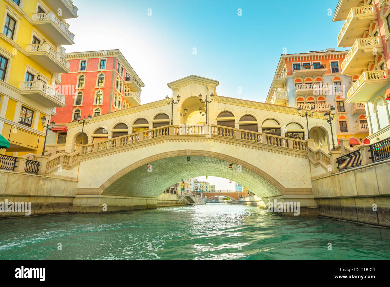 Bottom view of venetian bridge overlooking canals of picturesque Qanat Quartier icon of Doha, Qatar. Little venice at the Pearl, Persian Gulf, Middle Stock Photo