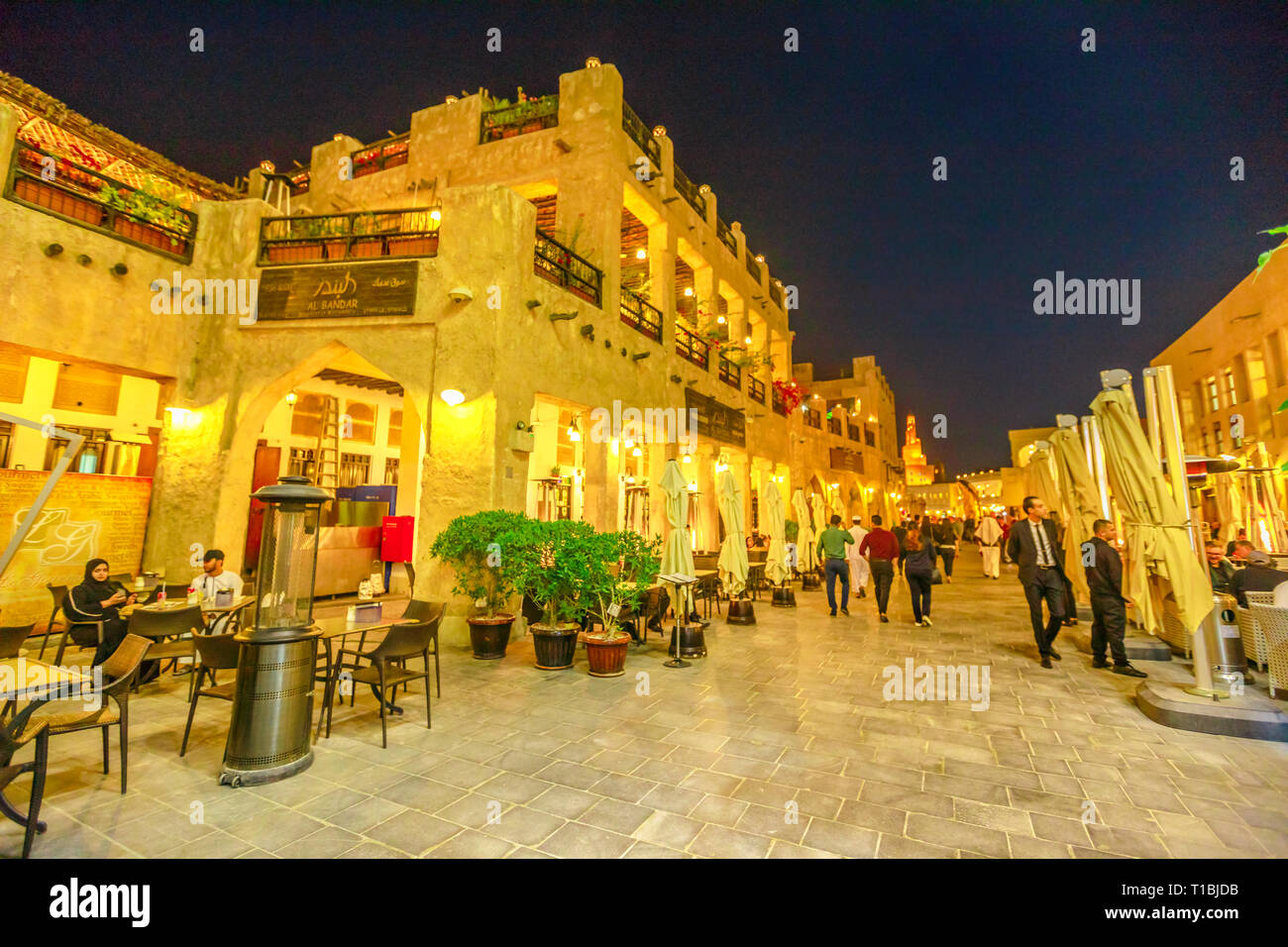 Doha, Qatar - February 17, 2019: Street view in Souq Waqif old traditional market with cafes and restaurants and the Fanar Islamic Cultural Center Stock Photo
