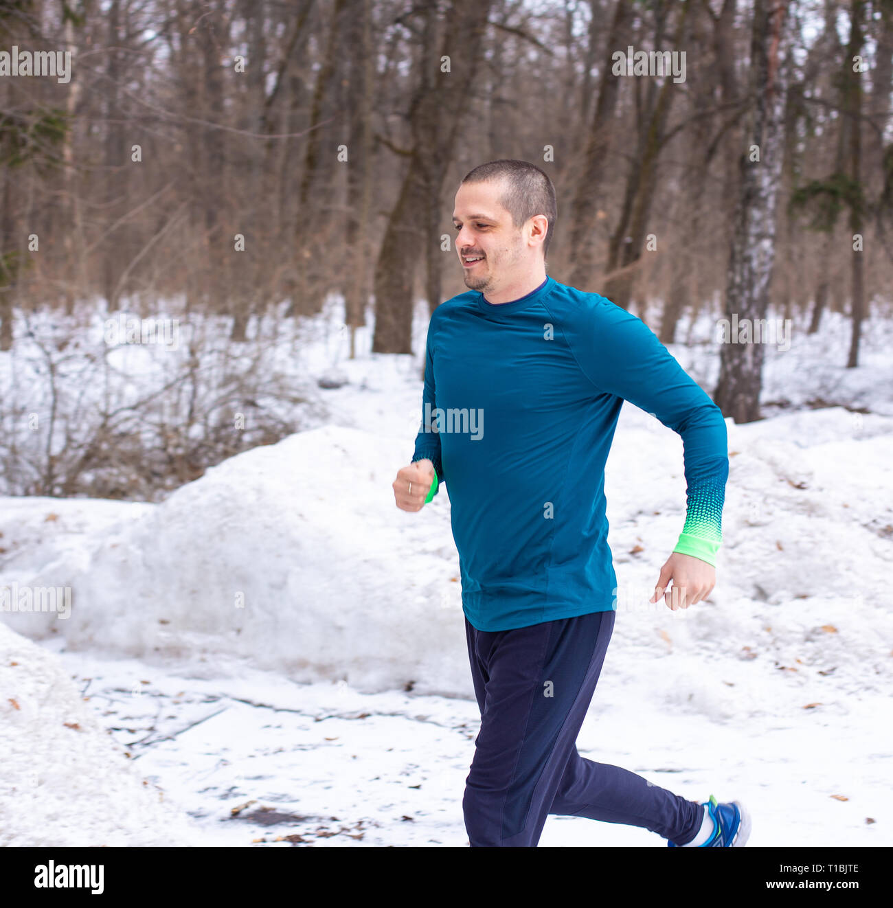 Runner adult man running outdoor in winter Stock Photo