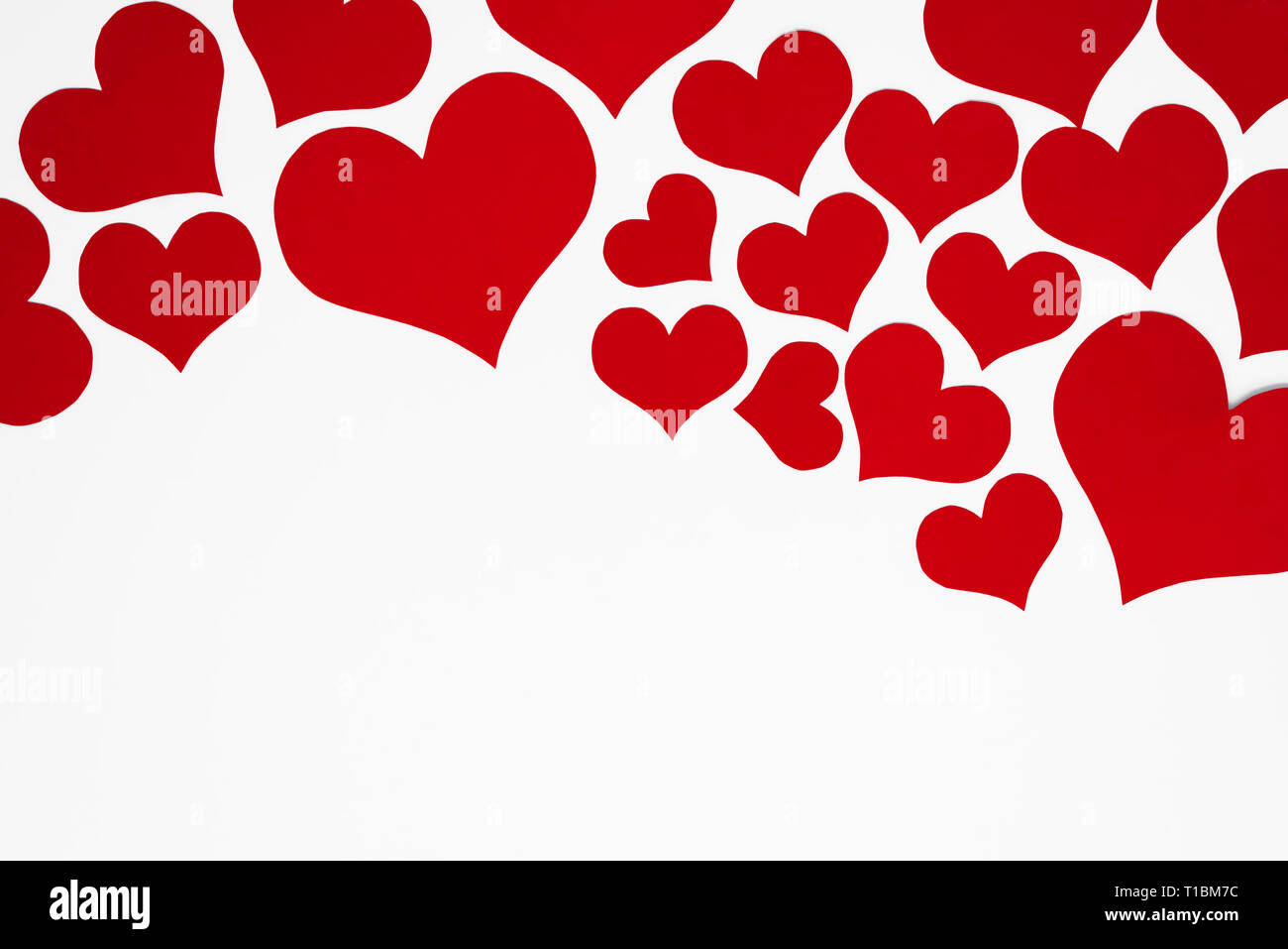 A lot of red hearts as a romantic top frame on white background, with ...