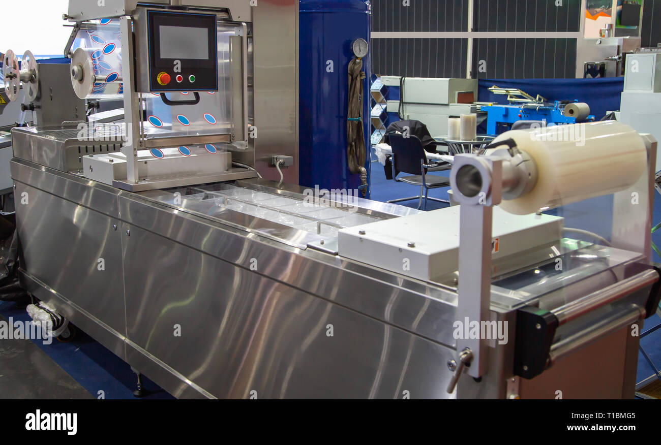 Linear tray food heat sealing and packaging machine Stock Photo Alamy