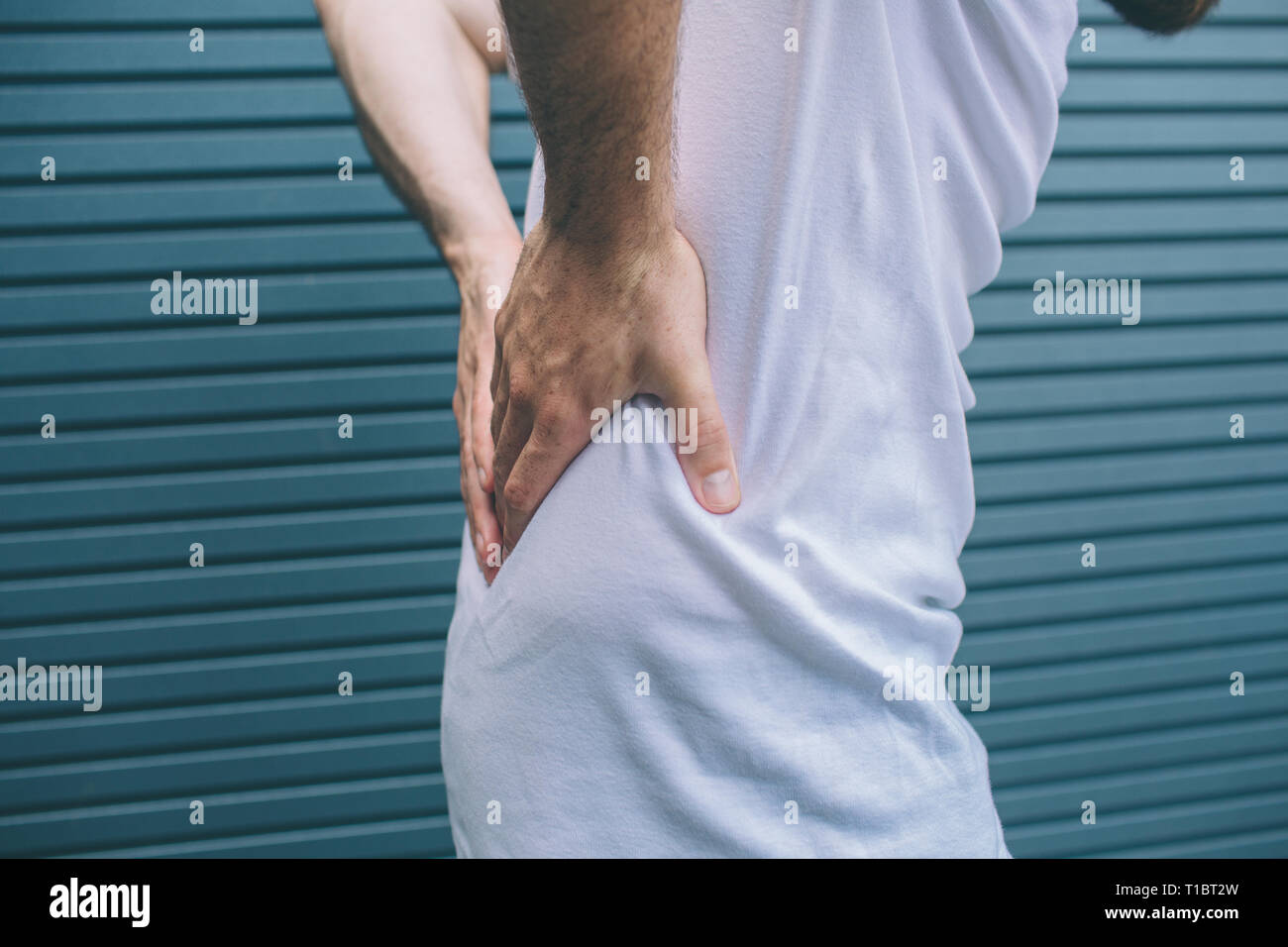 Cut view of man holding hands on back. It hurts. Guy is suffering ...