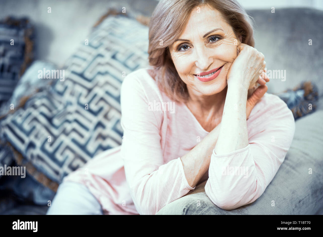 Portrait of a Woman Over 50 Who is Resting at Home in the Living Room. Stock Photo