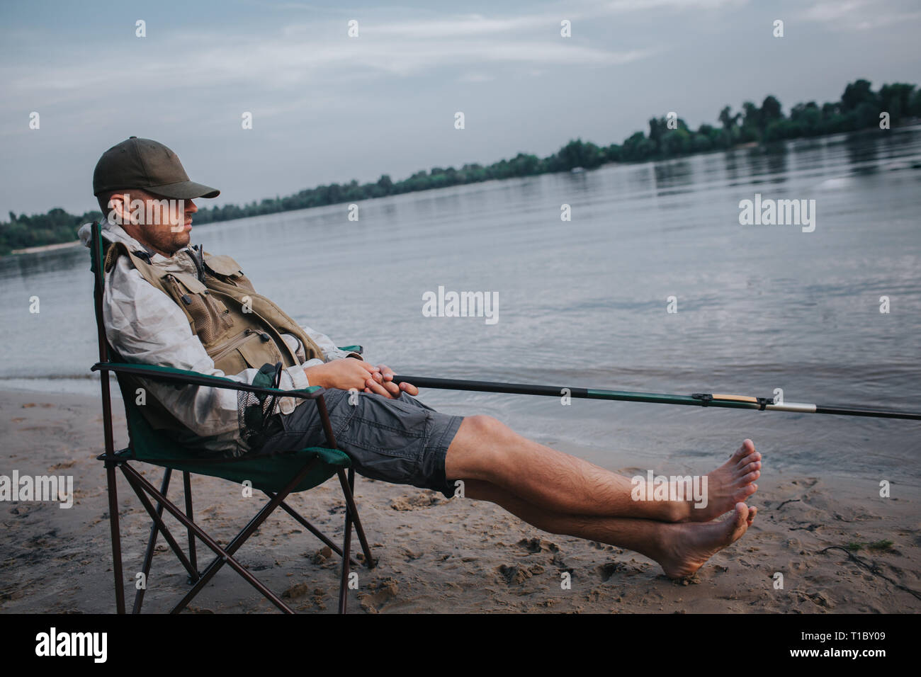 Man sitting in chair fishing hi-res stock photography and images - Alamy
