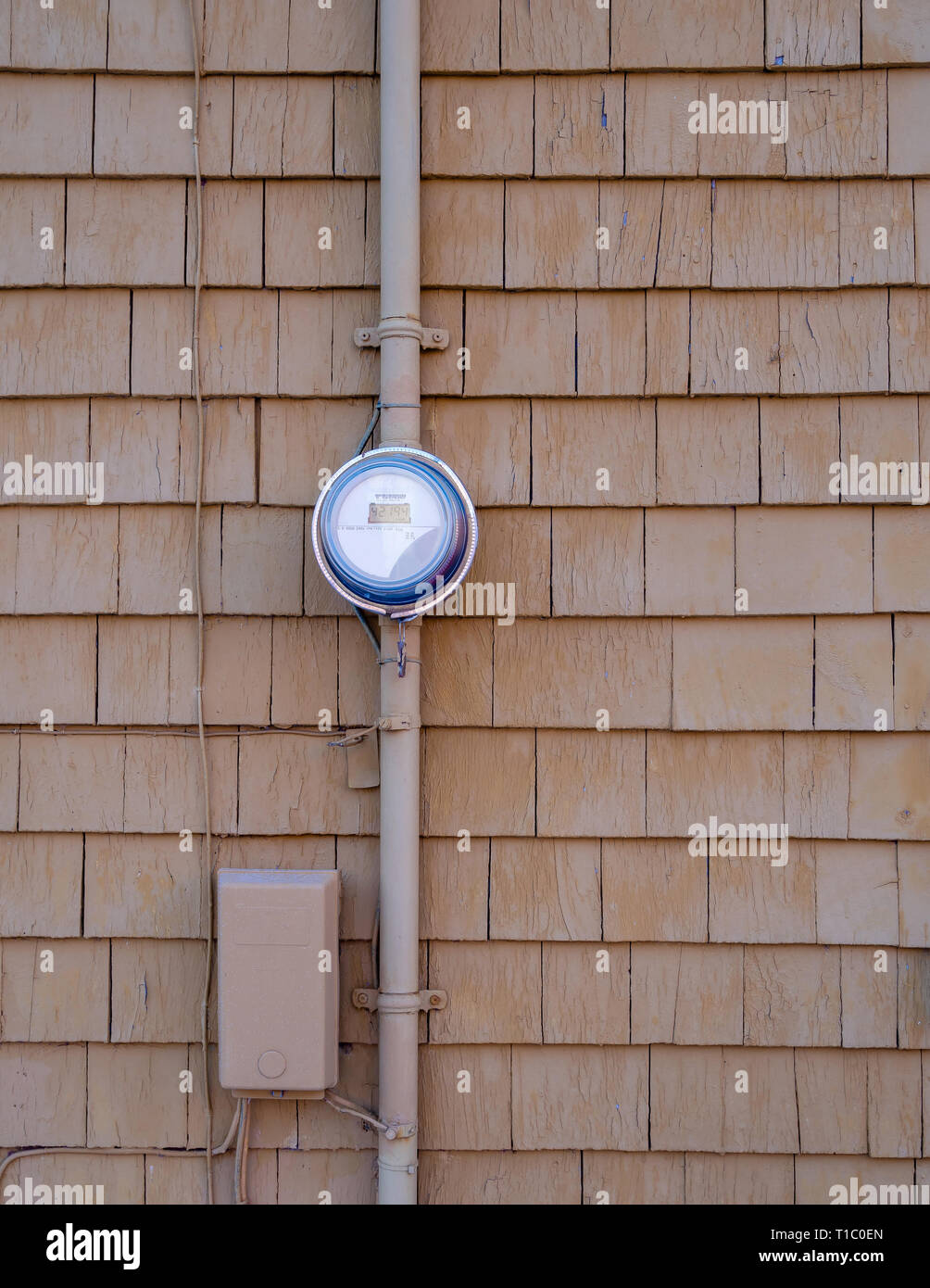 An old round digital electricity meter on cedar shingles in Charlottetown, Prince Edward Island, Canada Stock Photo