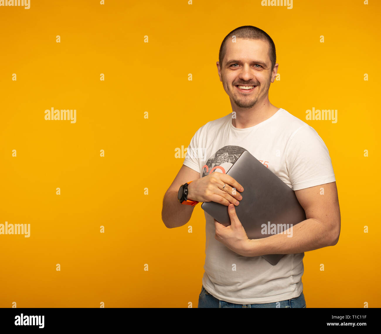 Developer or freelancer man holding laptop and smiling Stock Photo