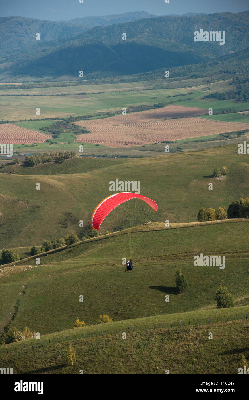 Paragliding in mountains Stock Photo