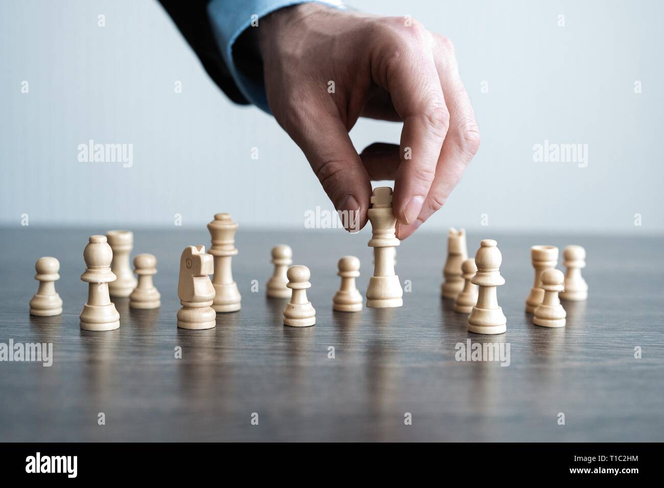 A skilled hand deftly slides a chess piece marked Chess across