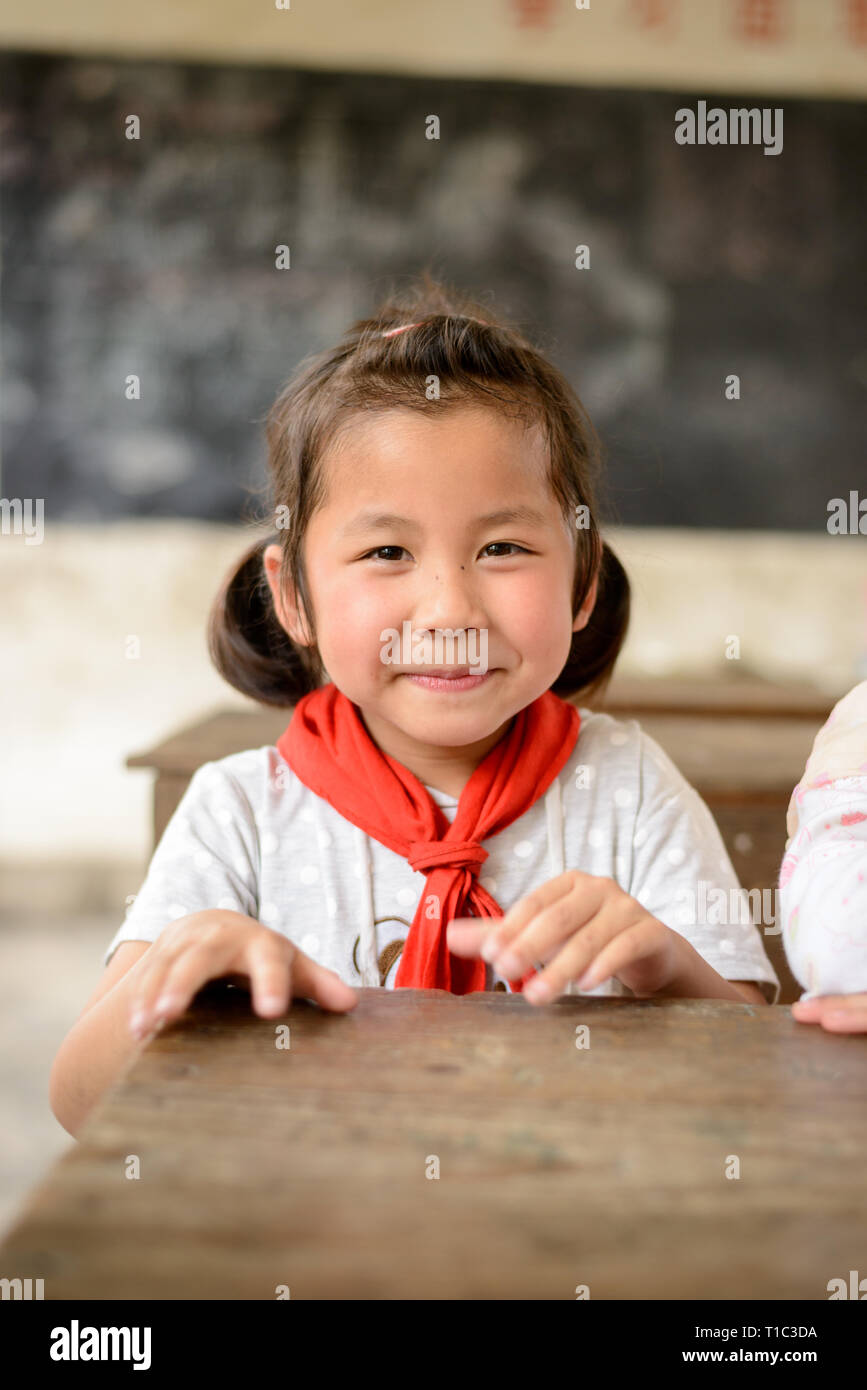 Elementary age school children attending class in a rural classroom in the Guangxi region of central southern China. Stock Photo
