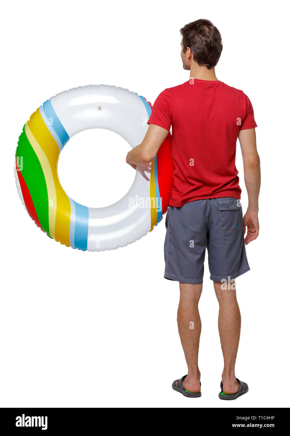 Back view of man in shorts with an inflatable circle. guy on the beach. Rear view people collection.  backside view of person. Isolated over white bac Stock Photo