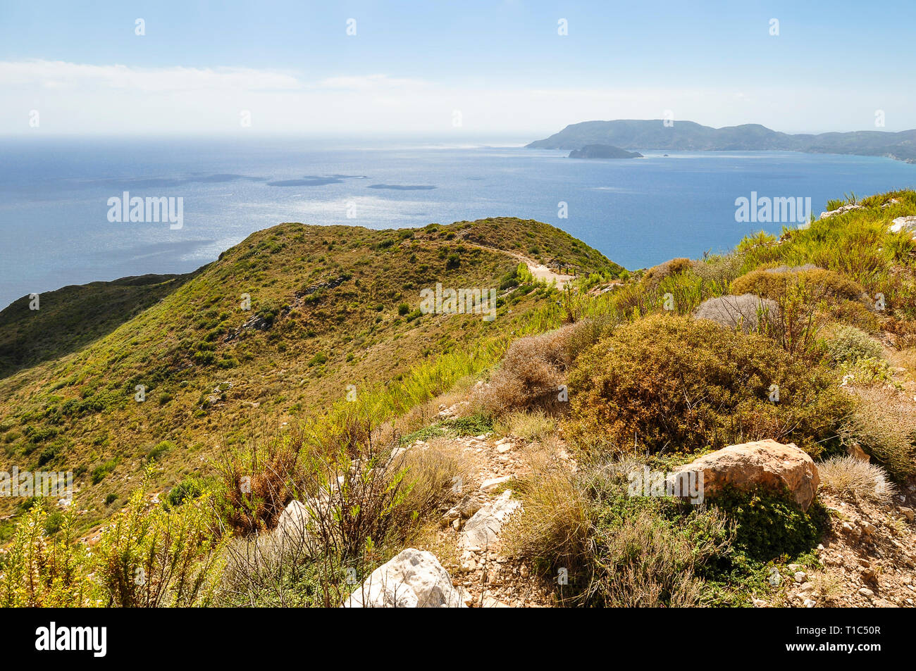 View from above on amazing, vacation landscape of bay greek sea, a bit of land and mountains. Colorful aerial view on blue sea and green hills during  Stock Photo