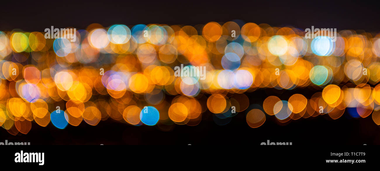 Blurred defocused city lights, Quito city, Ecuador. Abstract conceptual pattern as a banner expressing night city life, as wallpaper or background. Stock Photo