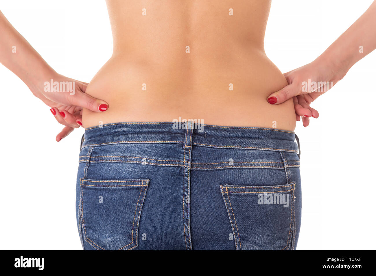 Woman measuring her belly fat with her hands. Stock Photo