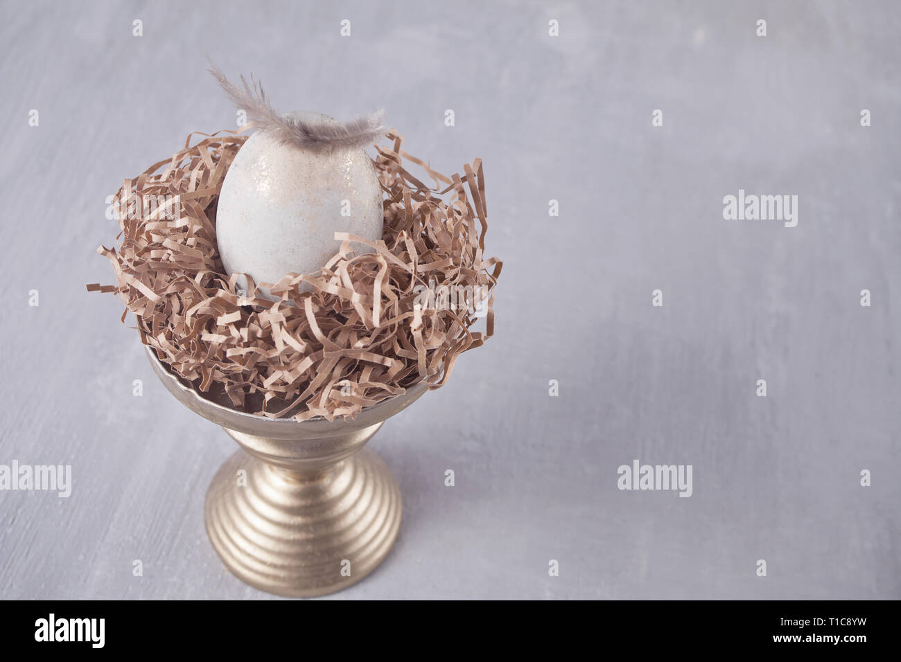 Easter egg on the table with feather Stock Photo