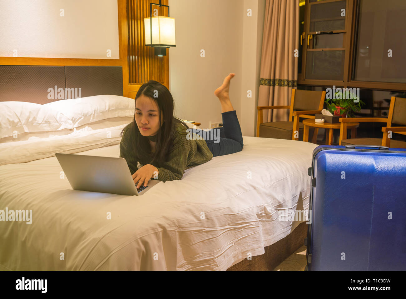 Young businesswoman working on laptop at night Stock Photo