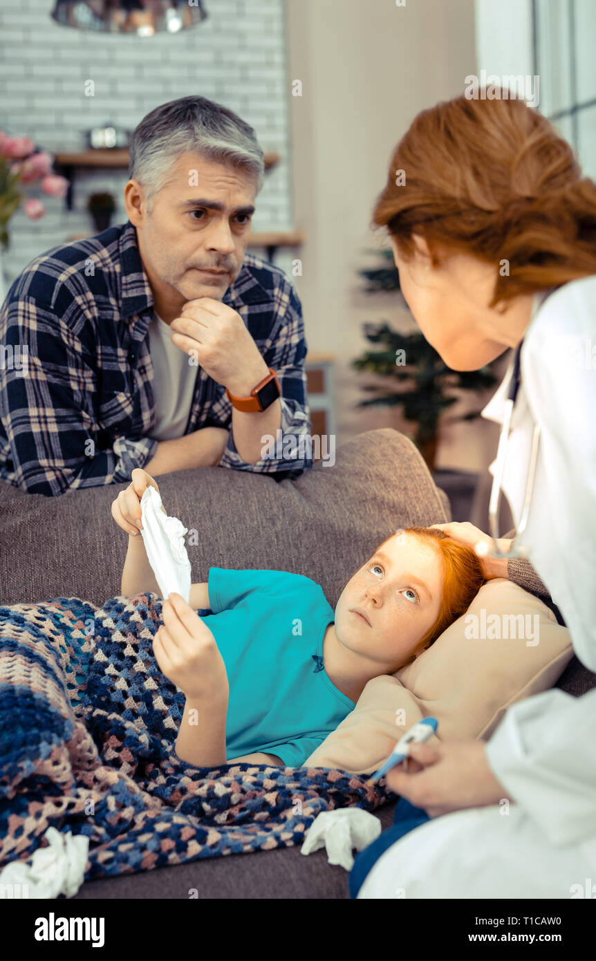 Nice serious man asking about his daughters state Stock Photo