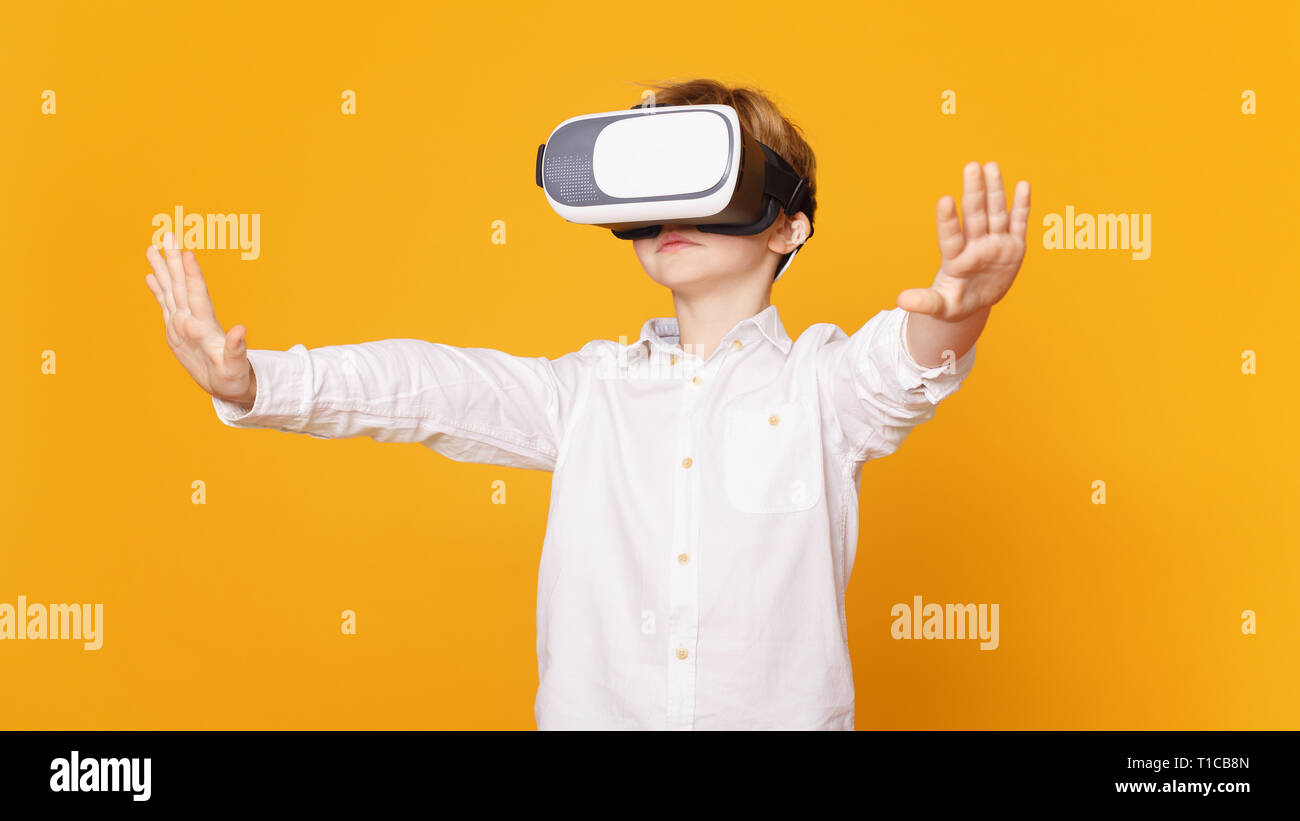 Preteen boy using virtual reality headset and gesturing Stock Photo