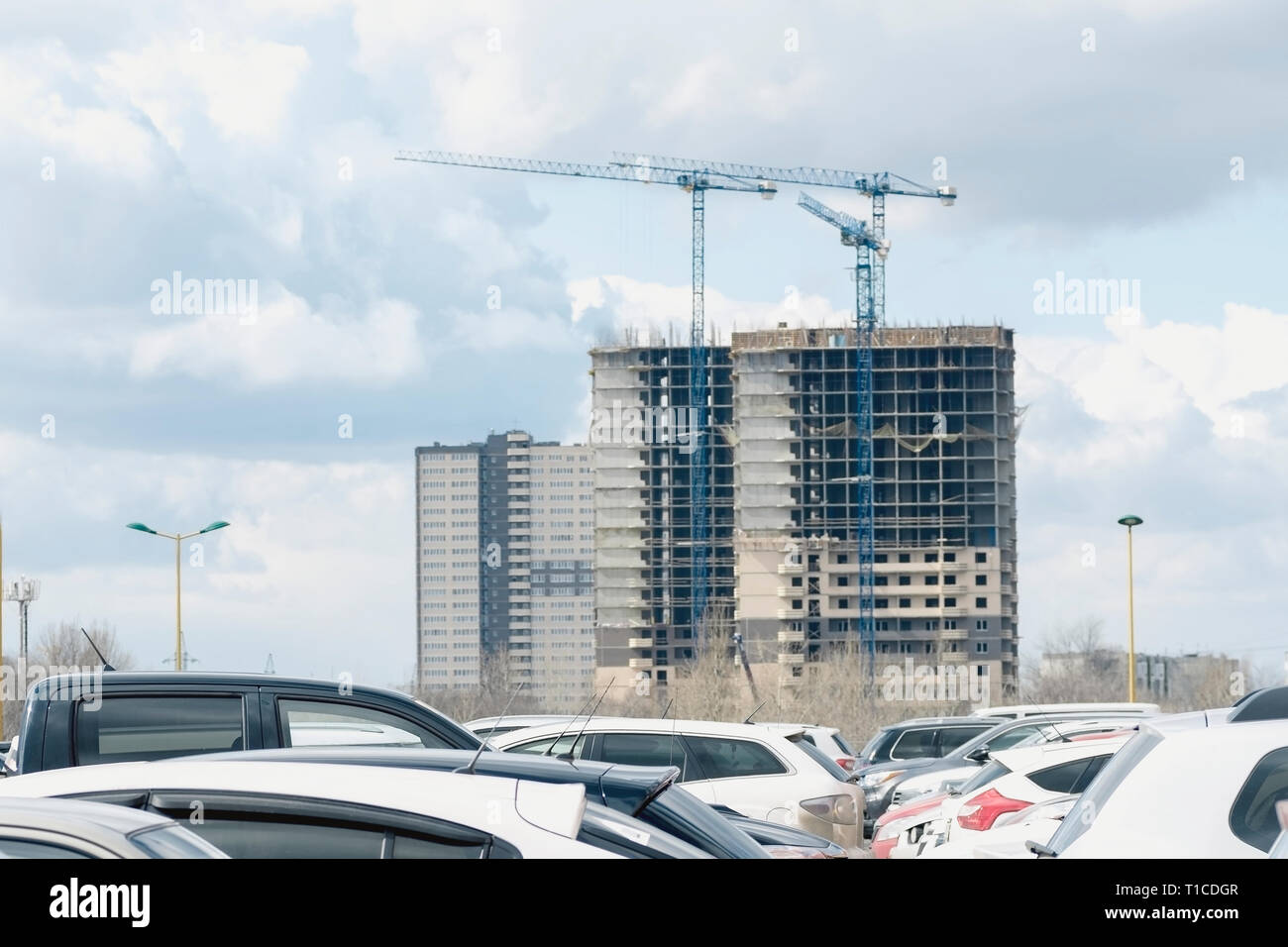 Modern building under construction, parking in the foreground Stock Photo