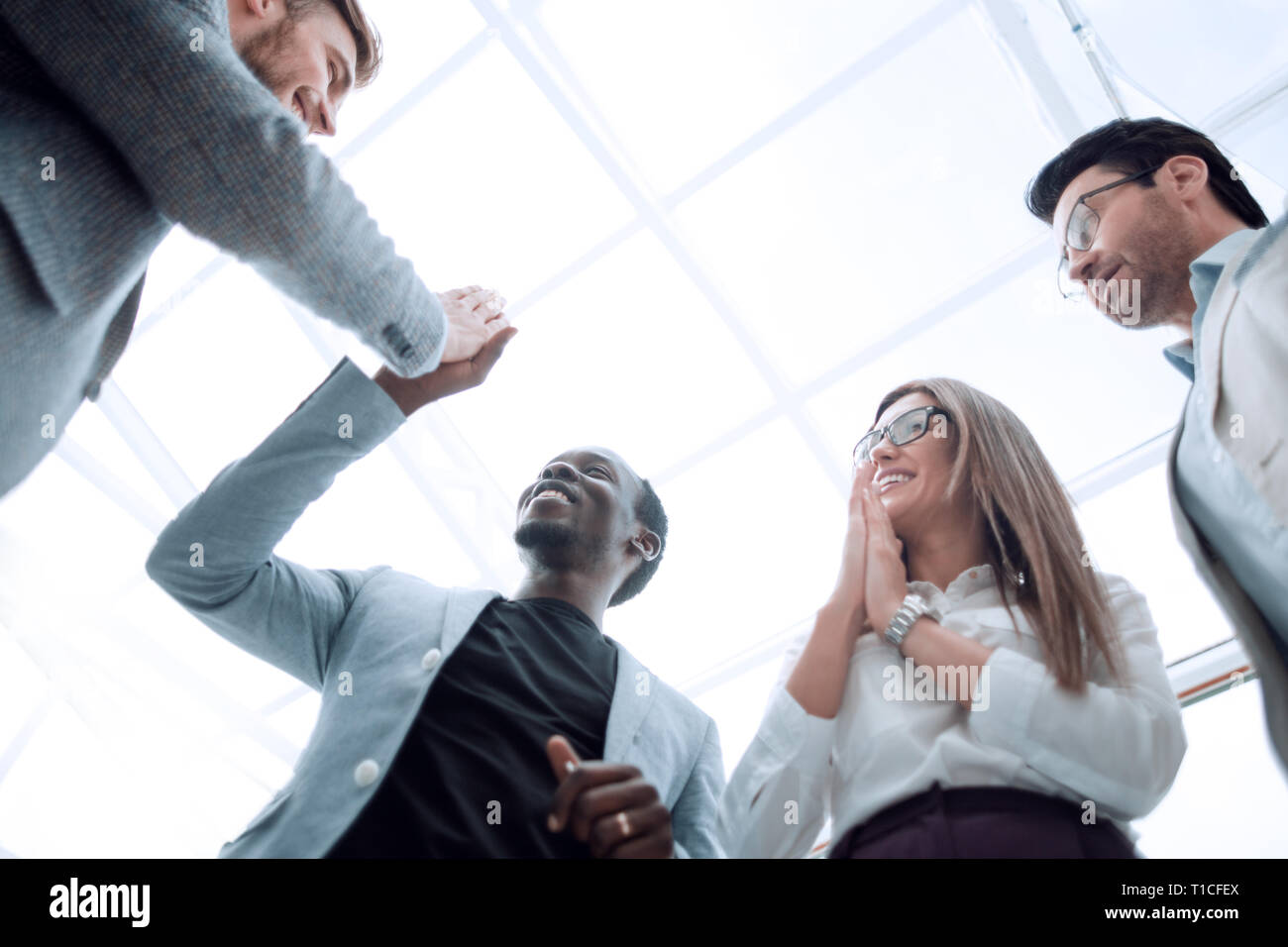 bottom view.happy employees giving each other a high five Stock Photo ...
