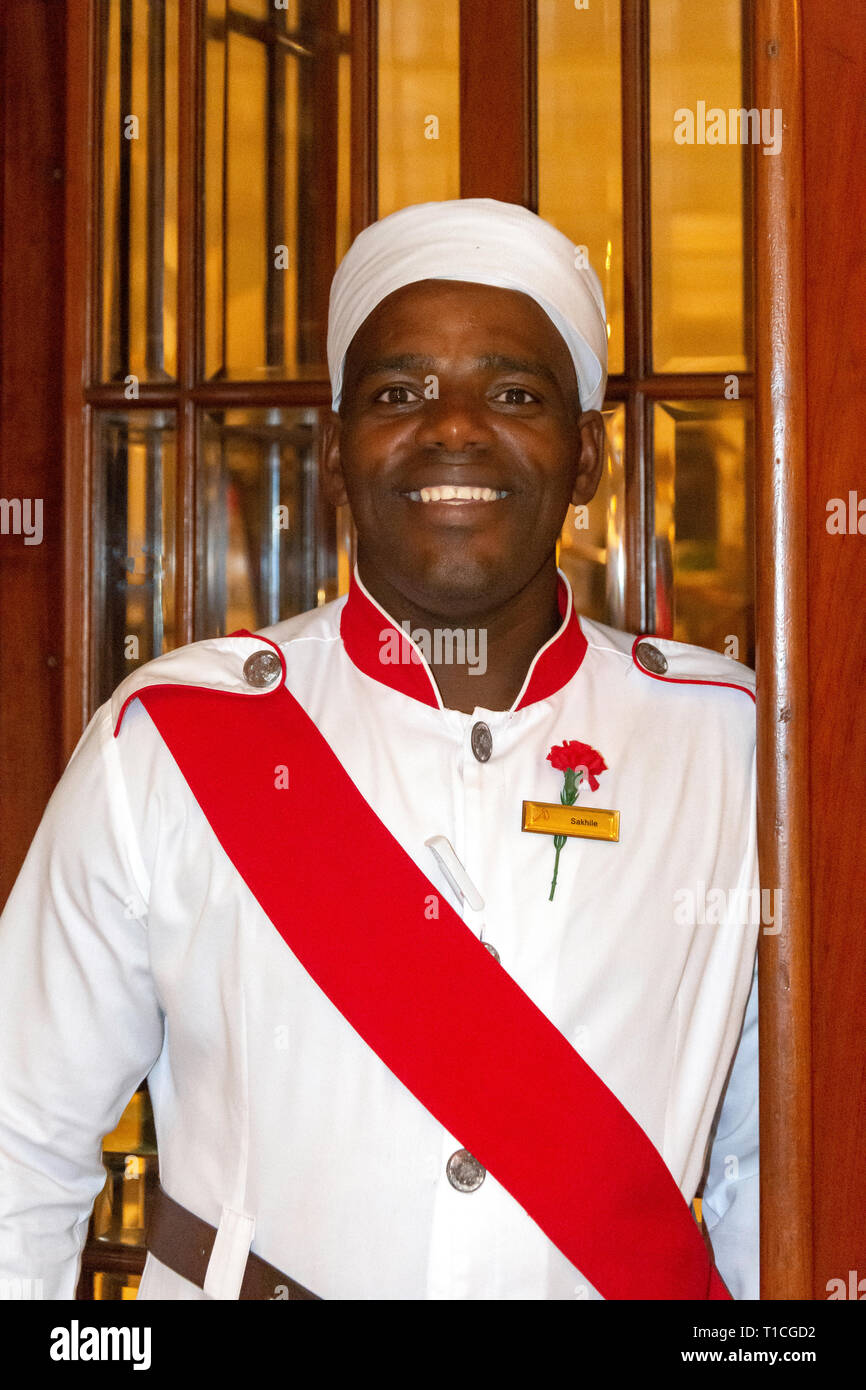 Historic porter bell boy traditional uniform reception desk inte hi-res