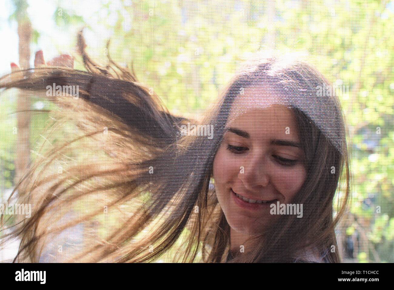 Portrait of a pretty girl smiling and flirting with camera Stock Photo ...