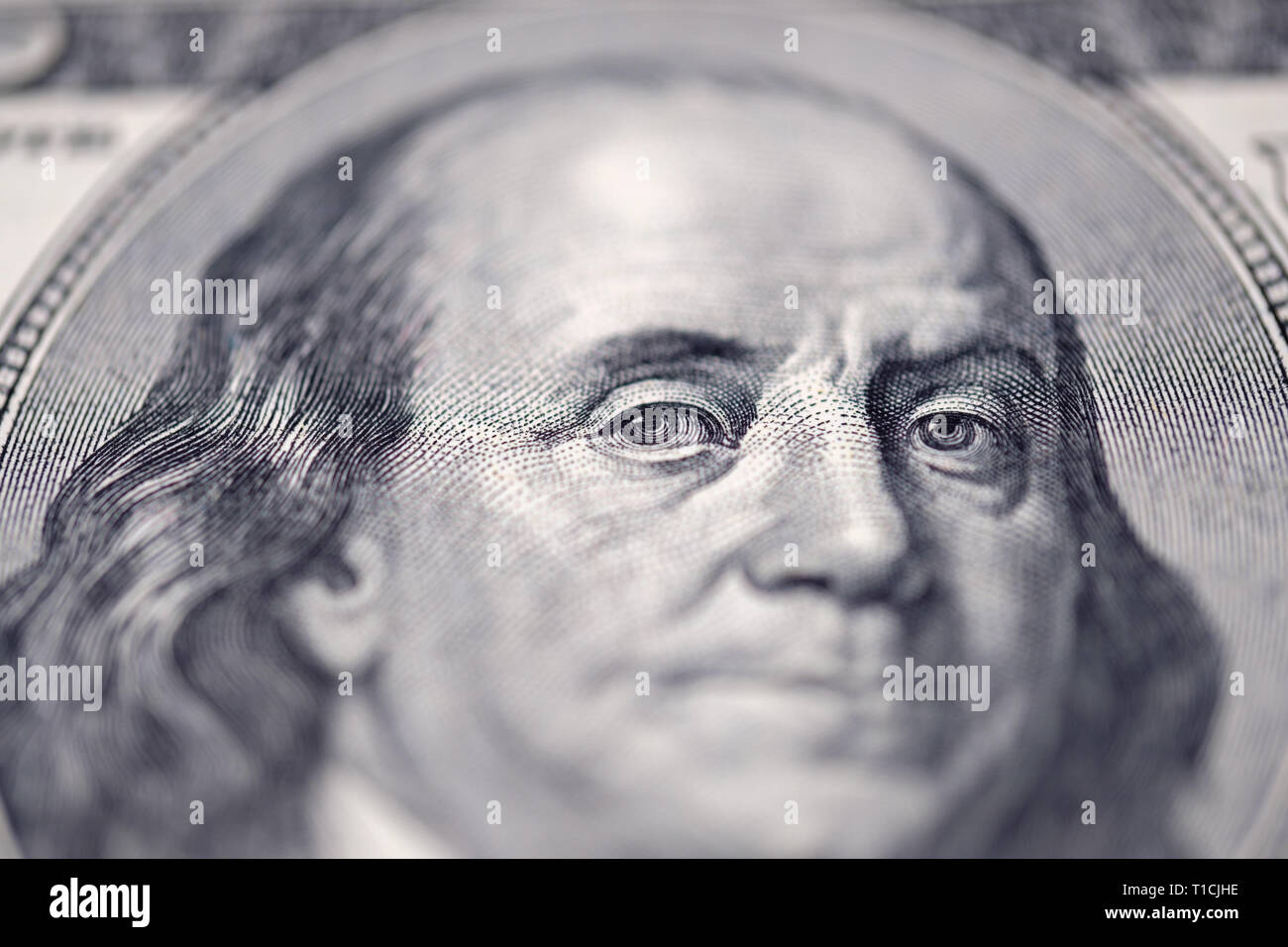 Benjamin Franklin on hundred dollars banknote. Selective focus on eyes. Stock Photo