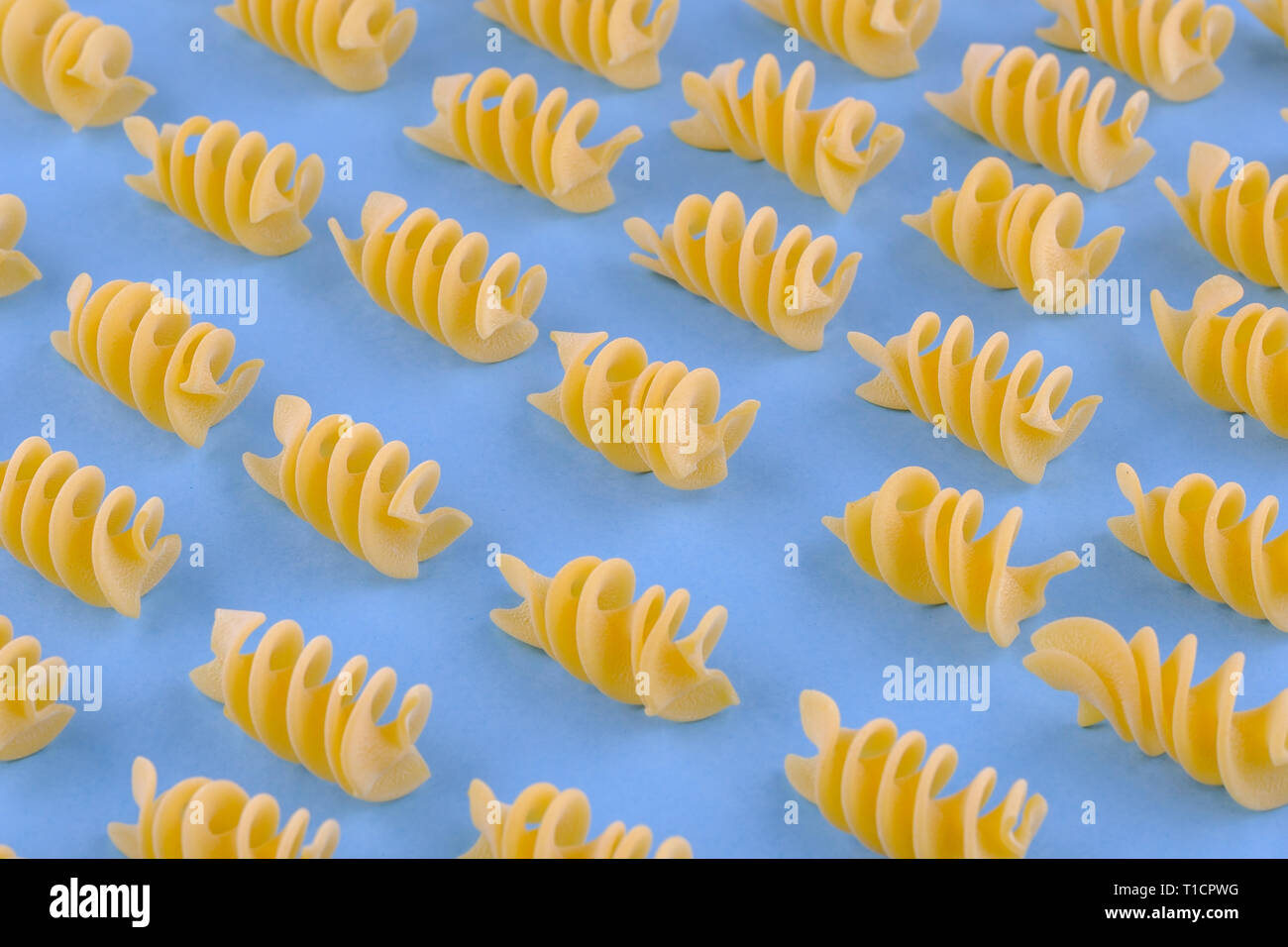Giant fusilli pasta on blue background. Close up view Stock Photo Alamy