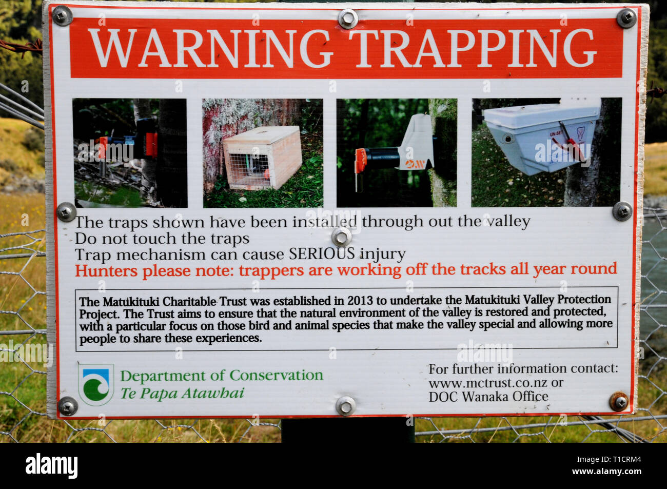 Warning signs for traps placed in the Matukituki Valley near Wanaka. These have been placed by the Matukituki Charitable Trust. Stock Photo