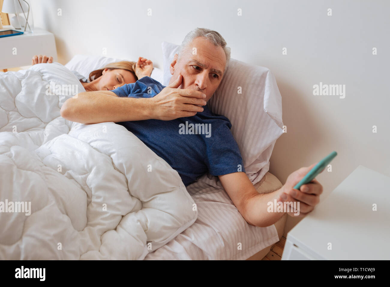 Dark-haired husband after seeing disturbing message from son Stock Photo