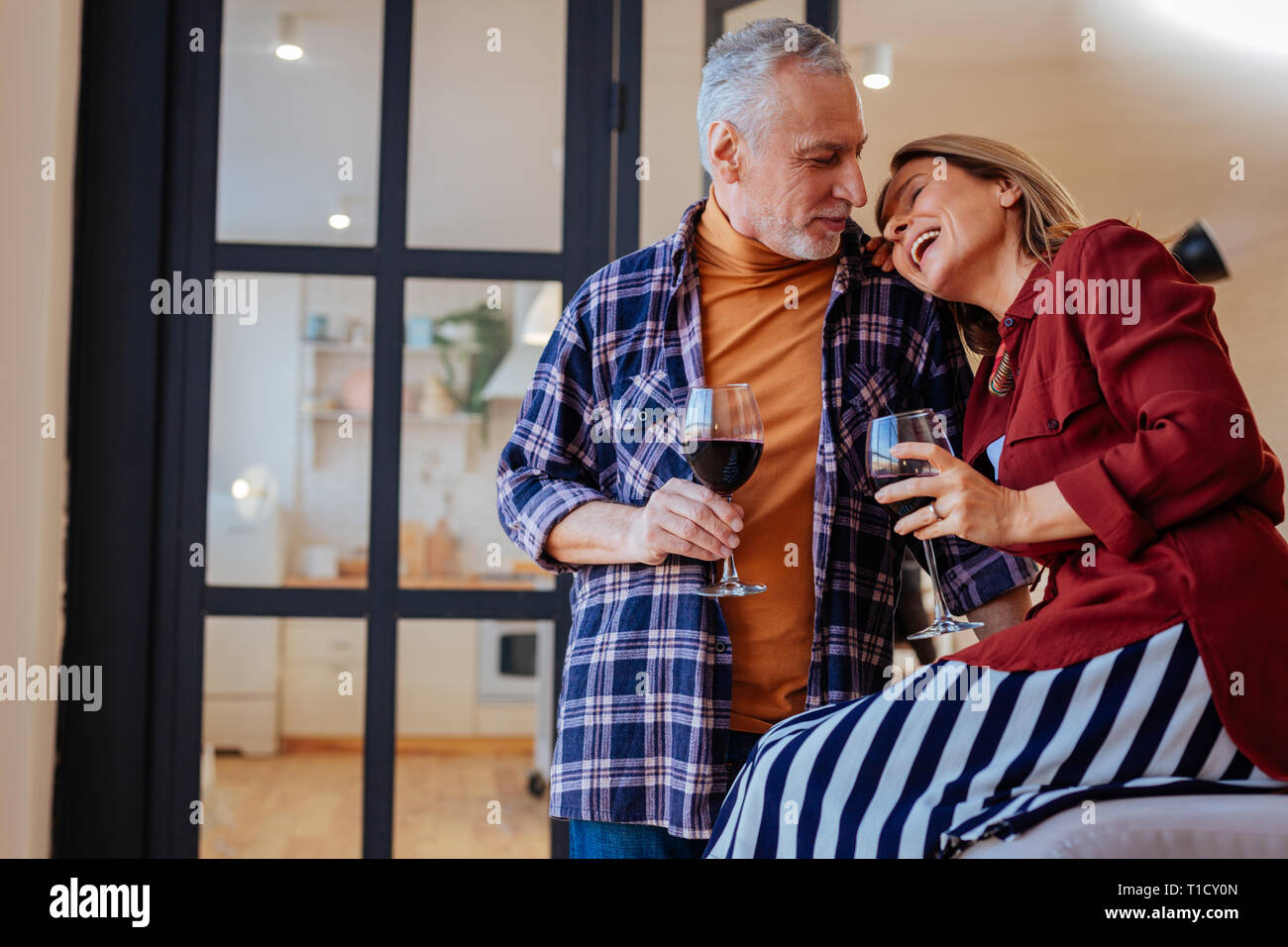 Cheerful laughing wife leaning on shoulder of her husband Stock Photo