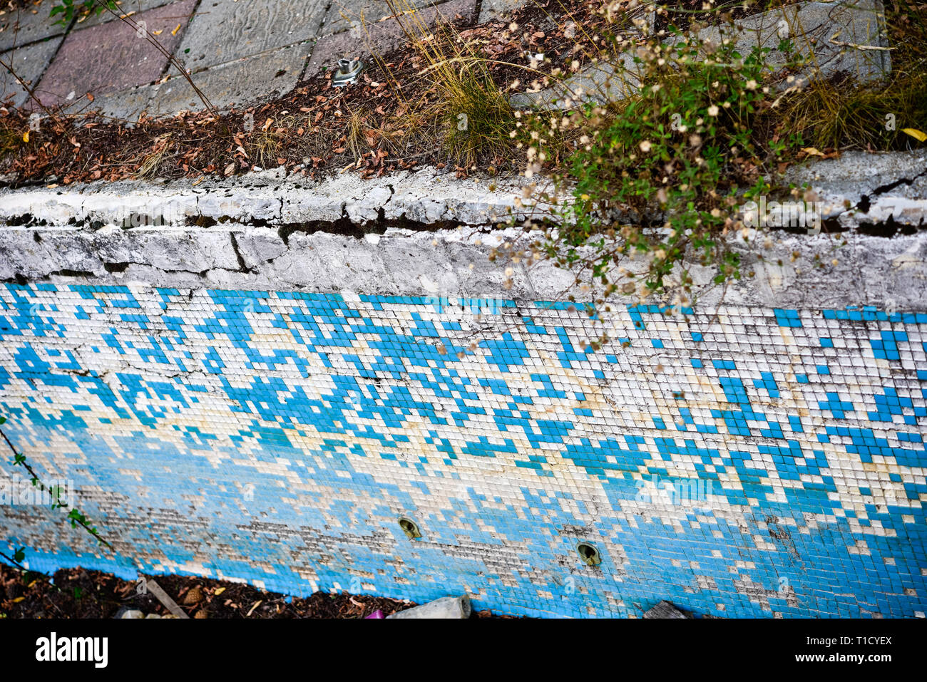 Broken blue azure retro tiles mosaic in abandoned pool - Berengaria Hotel, Cyprus Stock Photo