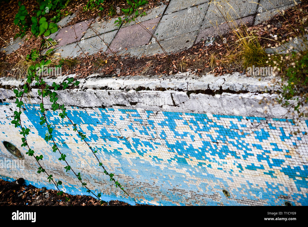 Broken blue azure  retro tiles mosaic in abandoned pool - Berengaria Hotel, Cyprus Stock Photo