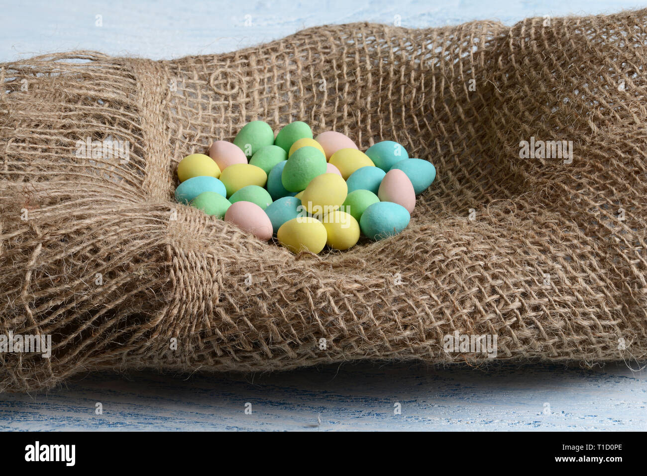 candy easter eggs in burlap nest Stock Photo Alamy