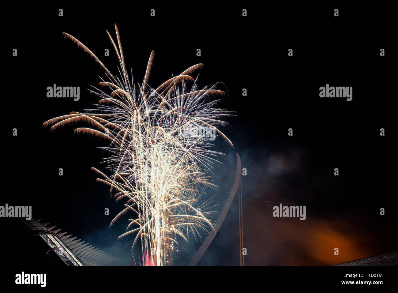 Colorful fireworks over the night city, free black space for text. Stock Photo