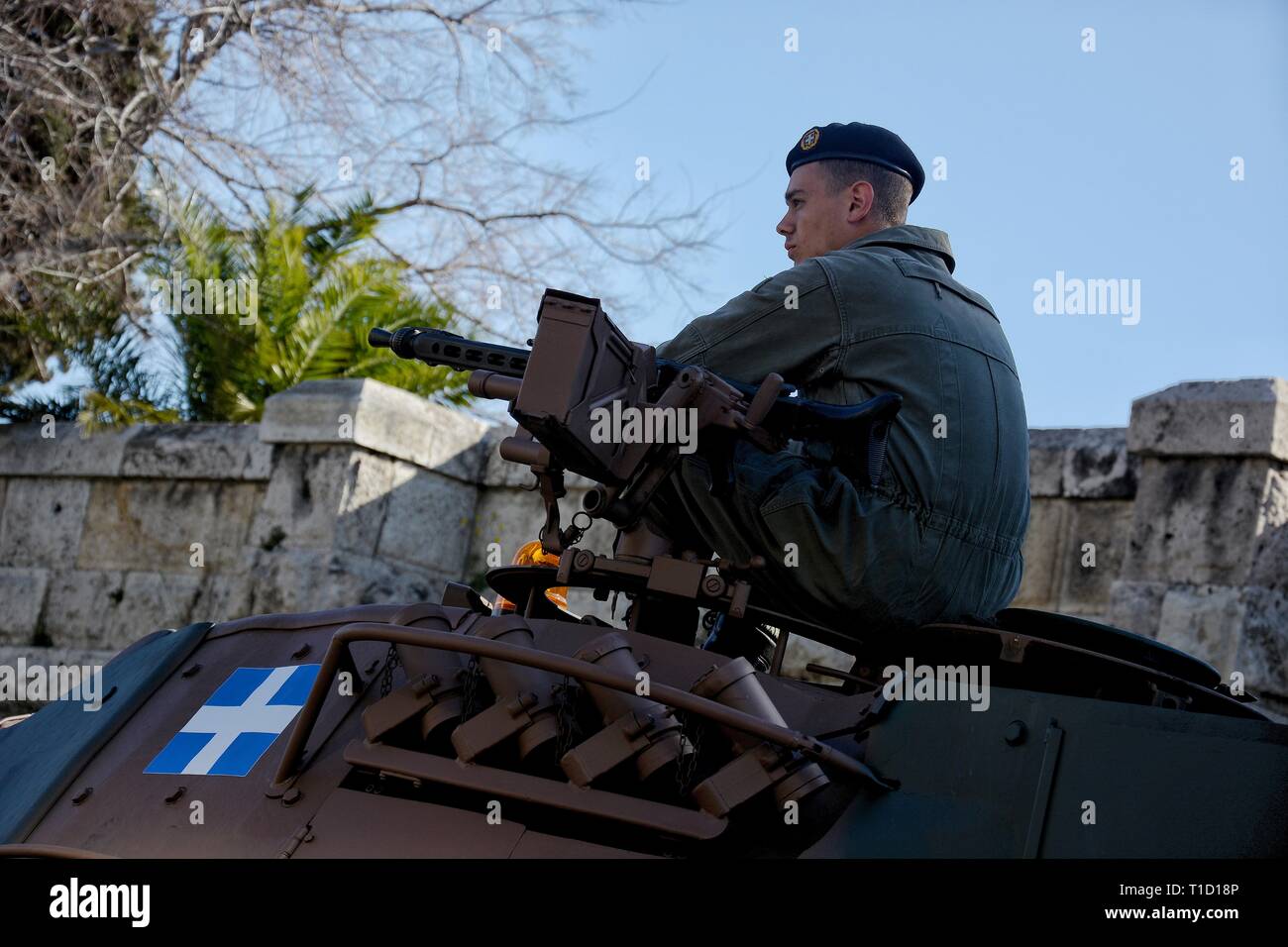 A member of Greek army seen seated on top of an armoured vehicle before the Military parade to commemorate the National Day in Athens. Stock Photo