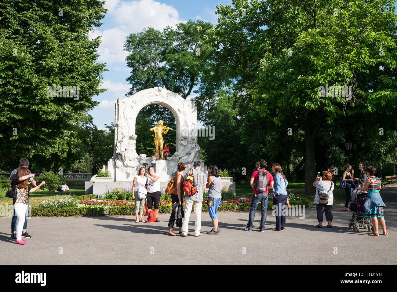 Johann Strauß II Monument in Stadtpark, Vienna with tourists taking photos on a sunny summer day. Stock Photo