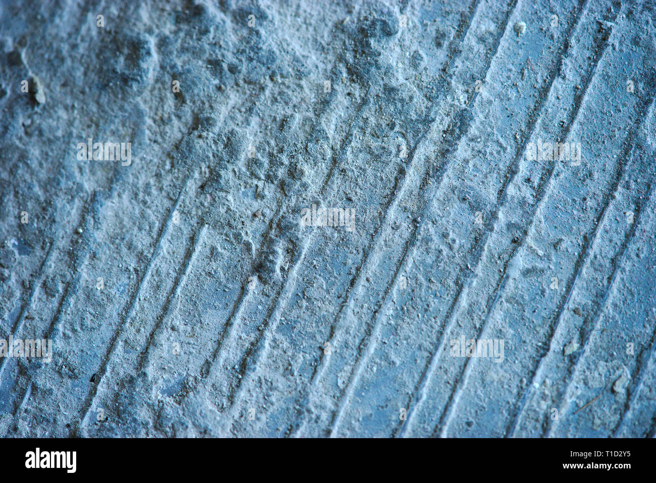 Uneven texture detail of hardened blue plaster, traces and relief Stock