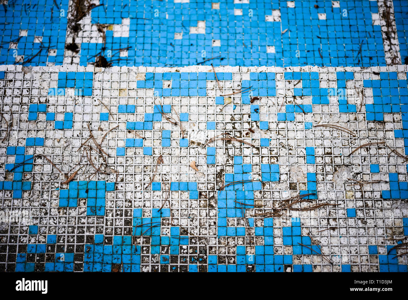 Broken blue azure  retro tiles mosaic in abandoned pool - Berengaria Hotel, Cyprus Stock Photo