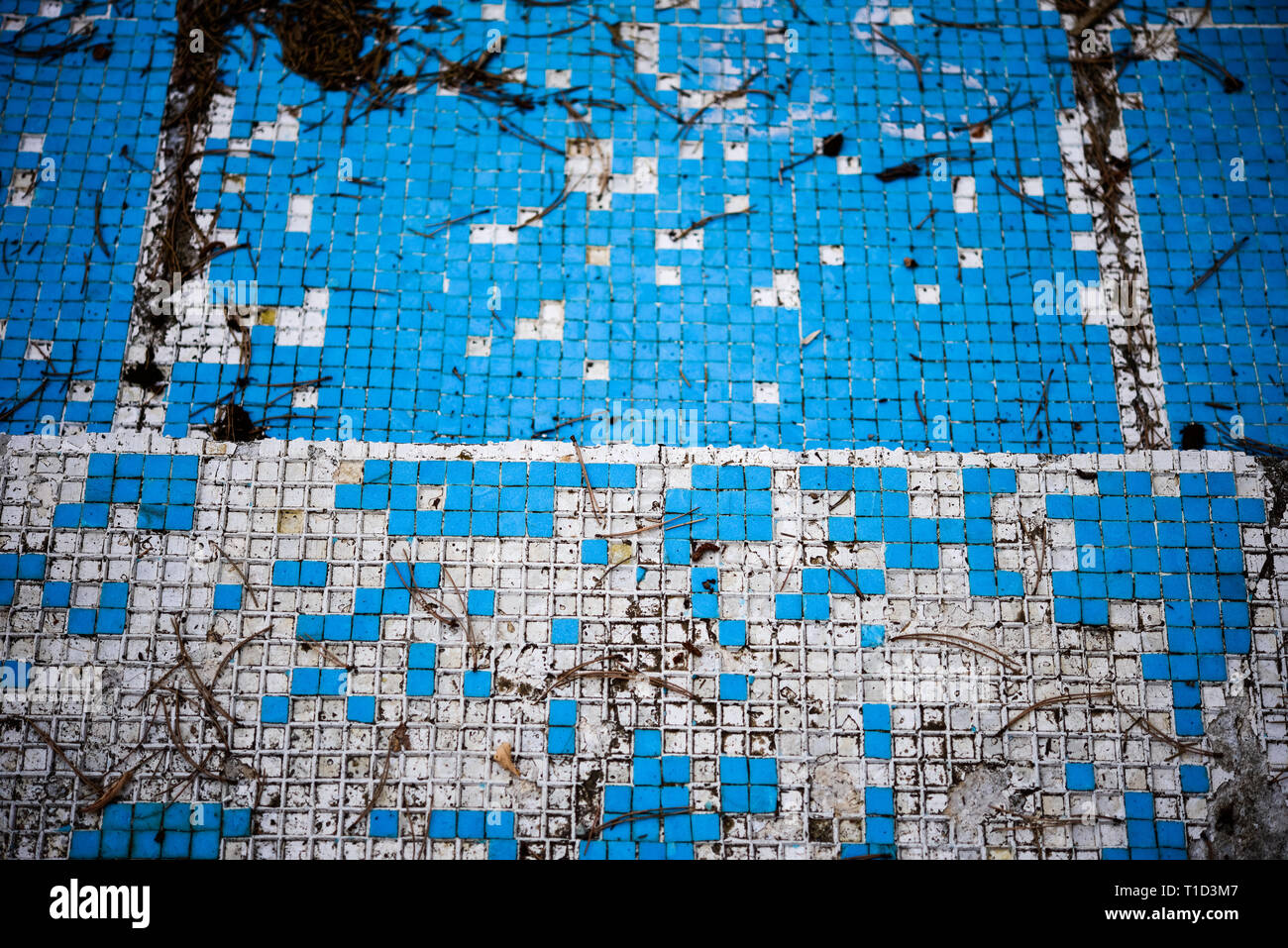 Broken blue azure  retro tiles mosaic in abandoned pool - Berengaria Hotel, Cyprus Stock Photo