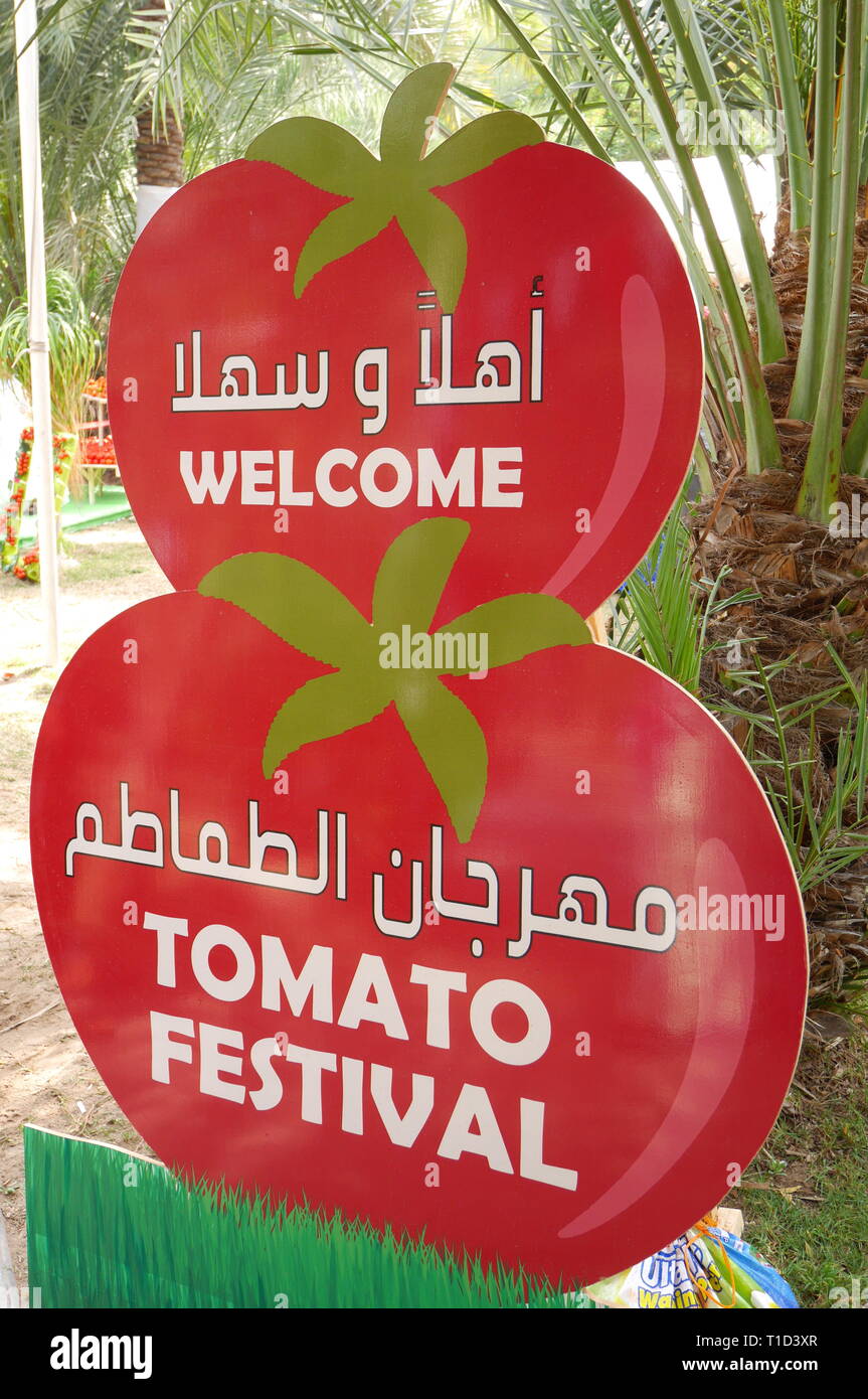Bilingual sign in Arabic and English to the Tomato Festival, farmer’s market, Budaiya, Kingdom of Bahrain Stock Photo
