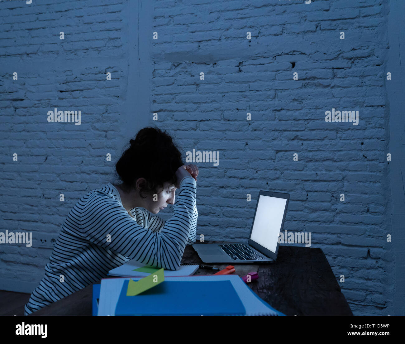 Overworked And Tired Female Student Working Late At Night On Her