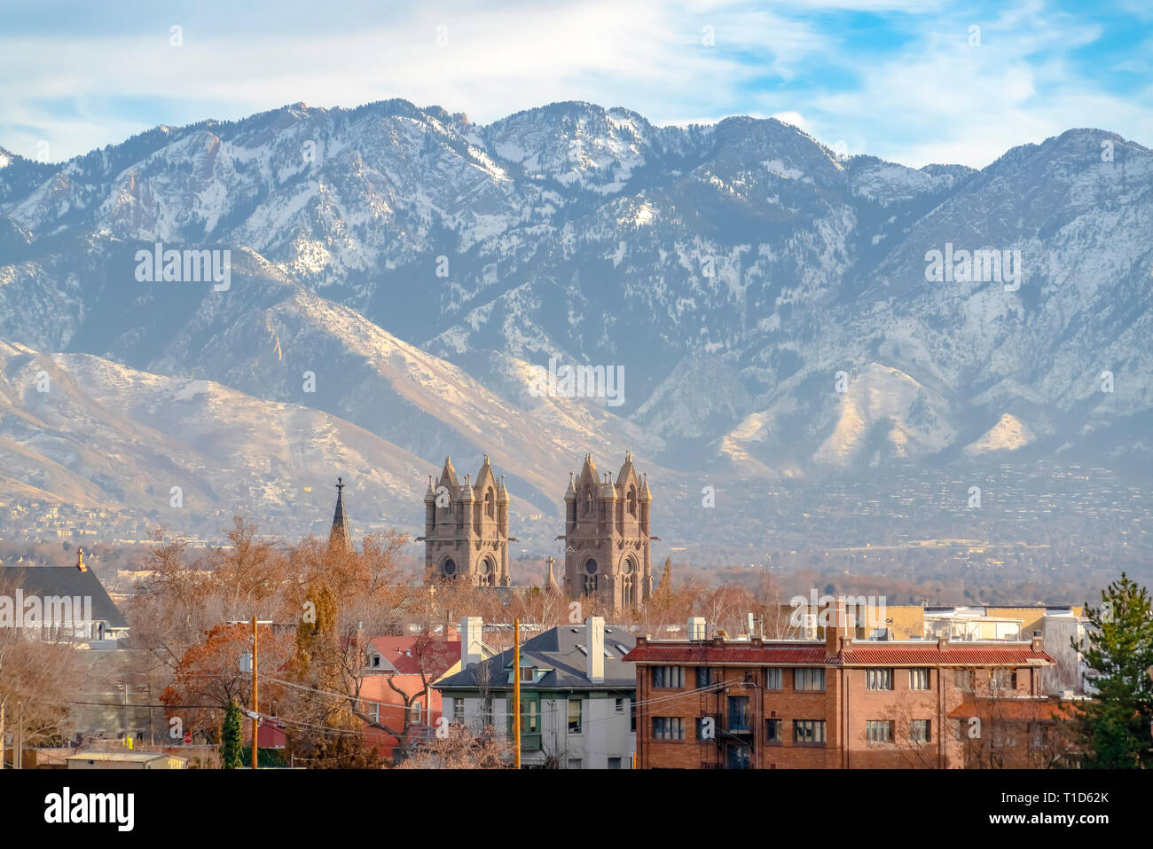 Cathedral of the Madeleine and Wasatch Mountain. Cathedral of the Madeleine towering over buildings in Salt Lake City, Utah. The immense Wasatch Mount Stock Photo
