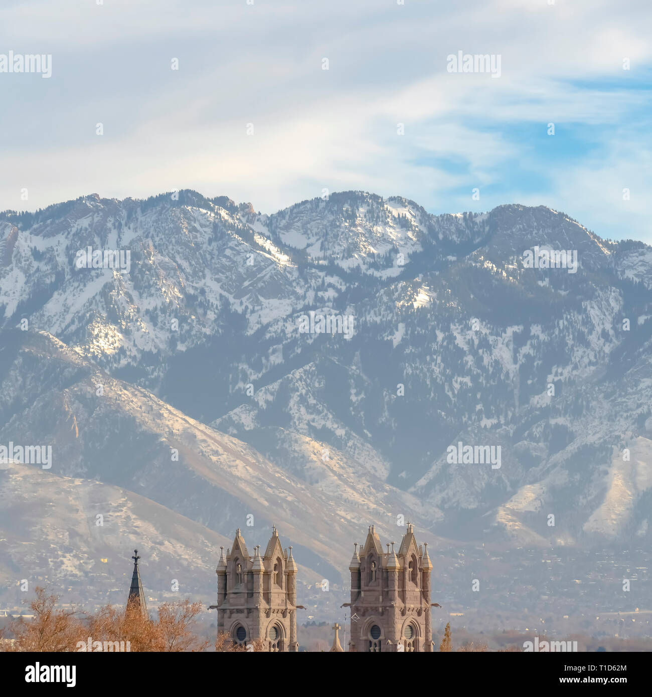 Cathedral of the Madeleine in Salt lake City Utah. The Cathedral of the Madeleine with Wasatch Mountain and cloudy sky in the background. It is one of Stock Photo