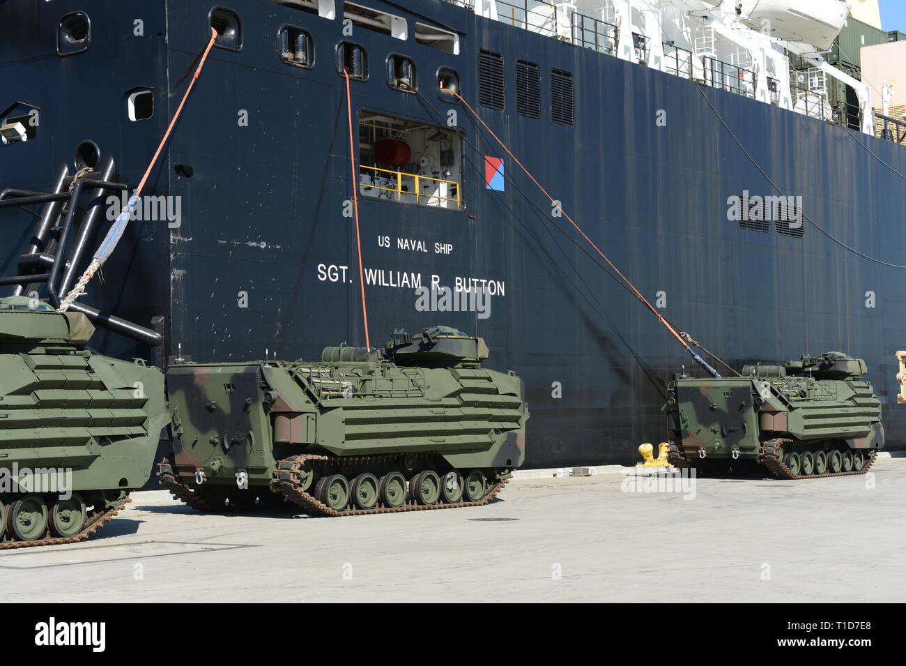 190318-N-MW964-1054 PORT HUENEME, Calif. (Mar. 13, 2019) Three amphibious assault vehicles (AAV-7A1) are offloaded from Military Sealift Command vessel USNS SGT William R. Button (T-AK 3012) in a maritime prepositioning force training evolution in Port Hueneme, California during Exercise Pacific Blitz 2019 (PacBlitz19). The inherently dynamic, scalable, and combined-arms capability of MAGTFs joined with mobility and sustainability provided by amphibious ships gives us an asymmetric advantage over adversaries.  PacBlitz19 increases the ability of all participants to plan, communicate and conduc Stock Photo