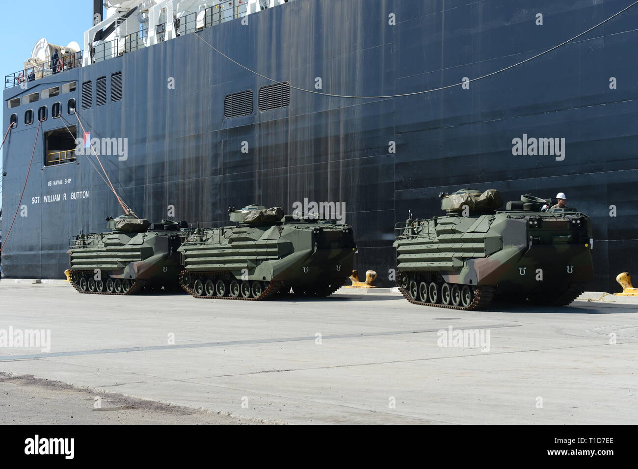 190318-N-MW964-1108 PORT HUENEME, Calif. (Mar. 13, 2019) Three amphibious assault vehicles (AAV-7A1) are offloaded from Military Sealift Command vessel USNS SGT William R. Button (T-AK 3012) in a maritime prepositioning force training evolution in Port Hueneme, California during Exercise Pacific Blitz 2019 (PacBlitz19). The inherently dynamic, scalable, and combined-arms capability of MAGTFs joined with mobility and sustainability provided by amphibious ships gives us an asymmetric advantage over adversaries.  PacBlitz19 increases the ability of all participants to plan, communicate and conduc Stock Photo